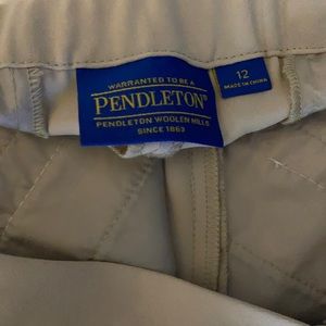 Woman’s khaki colored trousers.